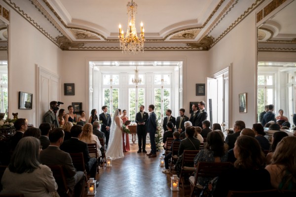 Bride groom guests seated and celebrant at alter during ceremony